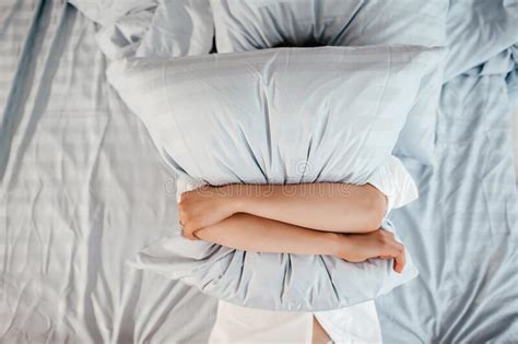 Too Lazy To Get Out Of Bed A Woman Covers Her Face With A Pillow