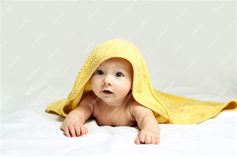 Premium Photo Adorable Happy Child With Blue Eyes In A Yellow Towel