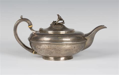 An Early Victorian Silver Teapot Of Squat Circular Form The Hinged Lid