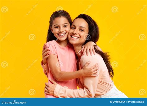 Love And Care Happy Young Mother Hugging Her Daughter And Smiling At