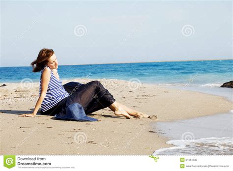 Beautiful Tanned Woman Resting On The Beach In Summer Day Stock Photo