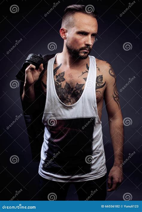 A Man With Tattooes On His Arms Silhouette Of Muscular Body Stock