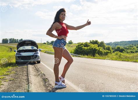 Beautiful Woman Hitchhiking By A Broken Car Girl Stands At His Car And Waiting For Help