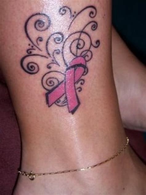 A cross and ribbon breast side tattoo: Ribbon Tattoos | Popular Tattoo Designs
