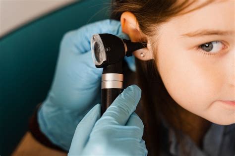 Close Up Examination Of Childs Ear With Otoscope Otoscopy Visit To