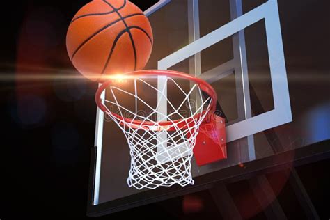 Basketball Heading To The Net At A Sports Arena With Lens Flare Stock