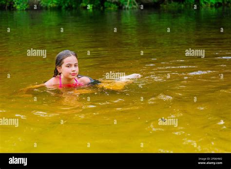 Small River Teenage Girl Enjoys The Warm Weather During The Summer