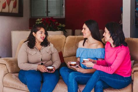 Latin Women Friends Hanging Out And Drinking Coffee In Home In Mexico