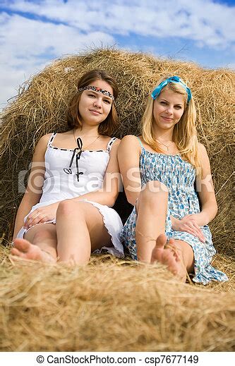Pretty Women Resting On Hay Pretty Women In Dresses Resting On Hay