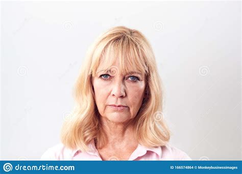 Studio Shot Of Unhappy And Frustrated Mature Woman Against White