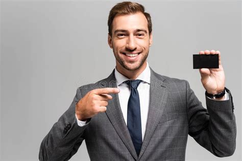 Smiling Businessman In Suit Pointing With Stock Photo Image Of