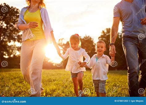 Young Children Walking With Parents In Park Stock Image Image Of