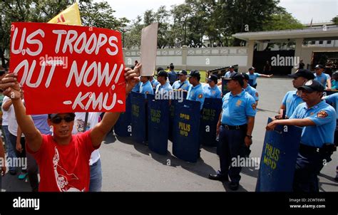 Protesters March Past Policemen Outside The Us Embassy In Manila
