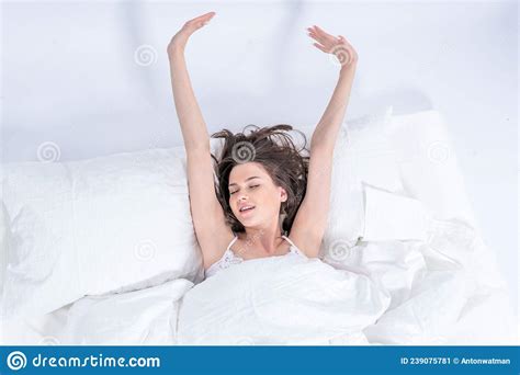 Wellness Concept A Young Beautiful Brunette Woman Wakes Up In Her Bed