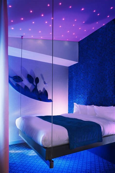 Whimsical lighting and a hanging bed create such a unique space t