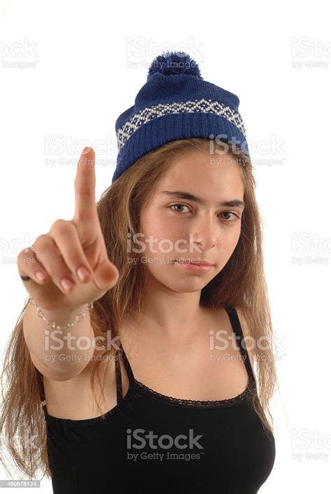 Happy Teenager Girl Pointing Her Finger On White Background Stock Photo