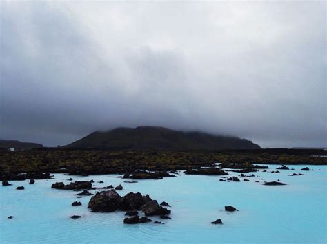 A Body Of Blue Water Surrounded By Rocks