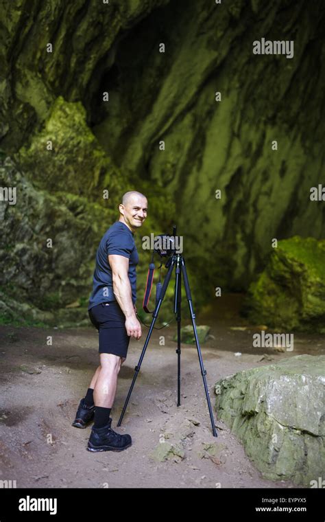 Professional Landscape Photographer Taking Shots In A Cave Stock Photo