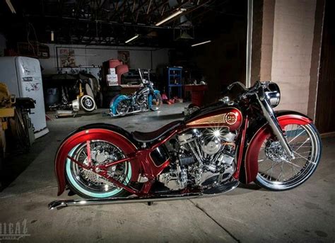 A Red And Black Motorcycle Parked In A Garage