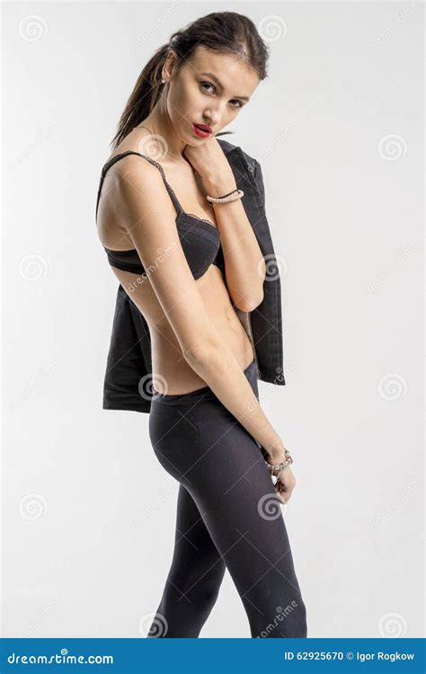 Slender Brunette Girl Removes A Business Suit Undressing Stock Photo
