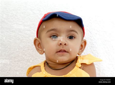 Indian Baby Face Portrait Yellow Dress Red Blue Hat Black Amulet White