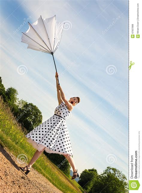 Pin Up Girl With A Umbrella Is Blowing Off The Path Stock Photo Image