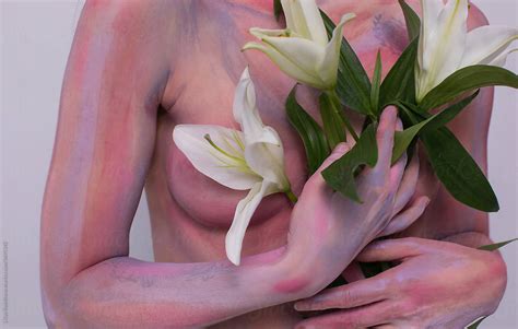 Woman With Pink Body Art Posing With Lilies Del Colaborador De Stocksy Liliya Rodnikova