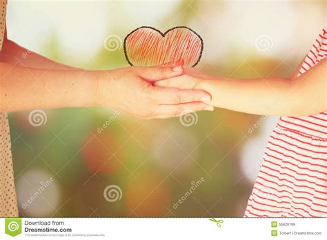 Mother And Child Holding Hands Over Blurred Background