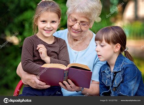 Education Concept Grandmother Reading A Book For Grandchildren Stock