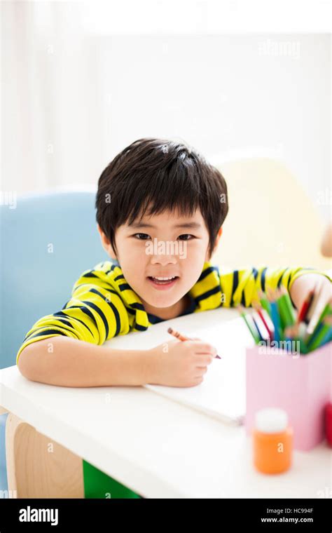 Portrait Of Smiling Boy Holding A Colored Pencil Snd Drawing Stock