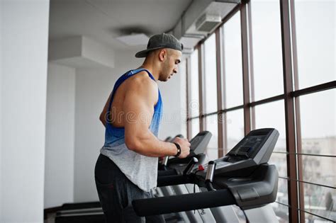 Fit And Muscular Arabian Man Running On Treadmill In Gym Stock Image