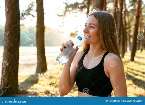 Smiling Girl Drinking A Water After Workout In The Park Stock Image