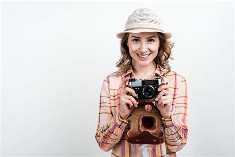 Girl Holding A Camera In Her Handisolated On A White Background