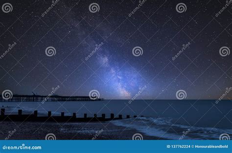 Vibrant Milky Way Composite Image Over Landscape Of Pier Under