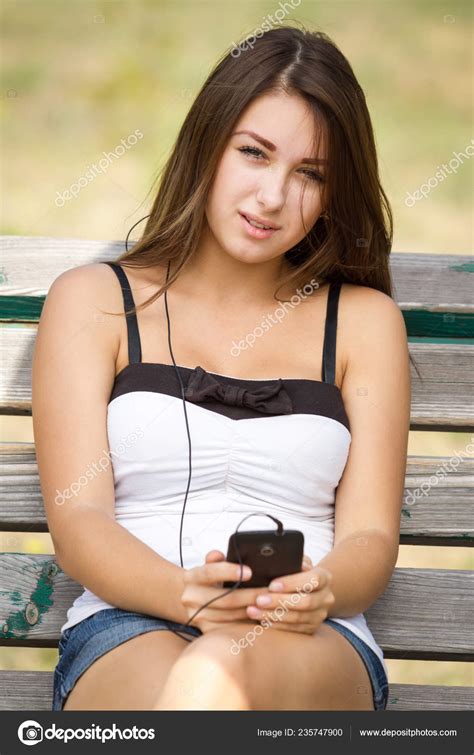 Beautiful Young Girl Playing Her Trendy Inch Smartphone Bench Park