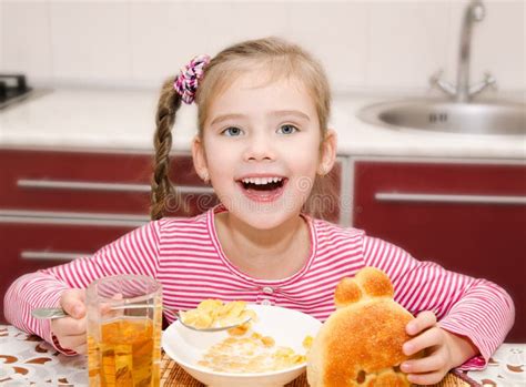 Cute Smiling Little Girl Having Breakfast Cereals With Milk Stock Image