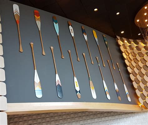 Wall Of Decorative Oars Each One Painted With A Different Pattern