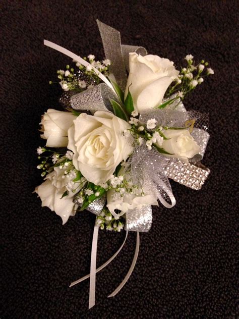 Wristlet corsage using a rhinestone wristlet. White spray roses and