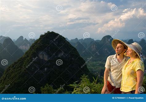 Couple Relaxing On Top Of The Mountain At Sunset Stock Image Image Of