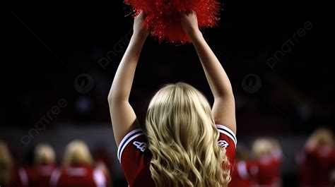 Cheerleader Is Holding Up Her Red Pom Poms Background Picture Of A Cheerleader Background Image