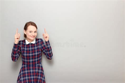 Happy Pretty Blond Girl Is Pointing With Fingers Upwards At Copy Space Stock Image Image Of