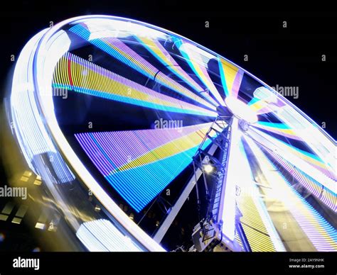 A Long Exposure Motion Blur Of A Spinning Ferris Wheel At Night