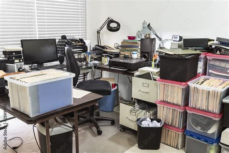 Messy Business Office With Cluttered Desk And Boxes Full Of Files