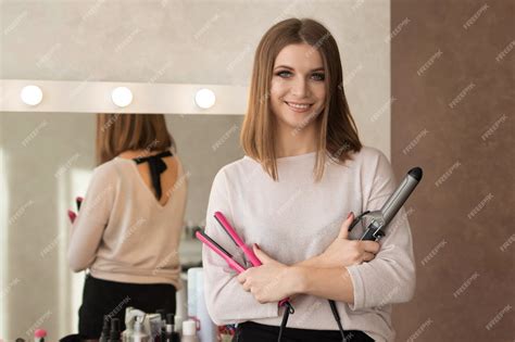 Premium Photo | Master of hairstyles woman with a working tool flat for