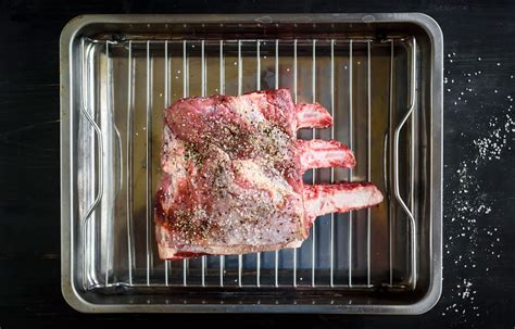 Following the line of the bones, cut the meat away from the bones in 1 piece. slow roasted boneless prime rib 200 degrees