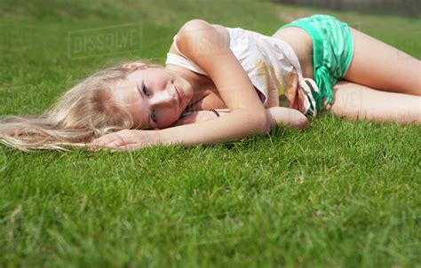 Austria Teenage Girl Lying On Meadow Smiling Portrait Stock Photo Dissolve