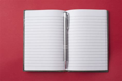 Free Stock Photo 5363 Opened Notebook With A Pen In The Centre