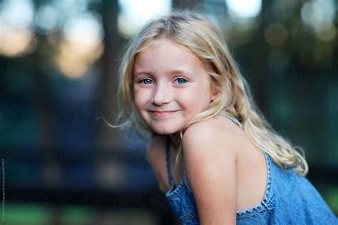 outdoor portrait of blonde girl wearing denim dress del colaborador de stocksy dina marie