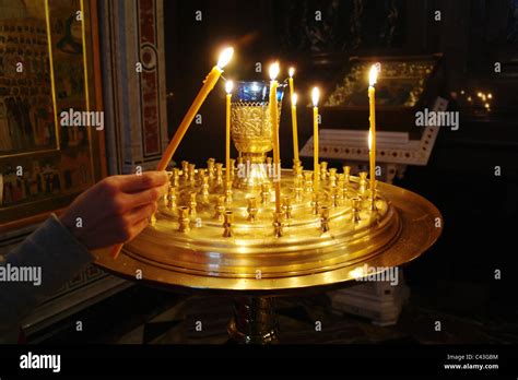 the christian girl in an orthodox temple lights a candle a temple of the christ of the savior