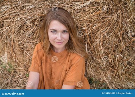 Woman Sitting Against Haystack Stock Photo Image Of Serene Caucasian